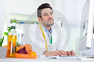 male dietician using computer photo