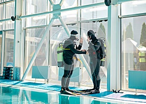 Male diver and divemaster in scuba gear, diving