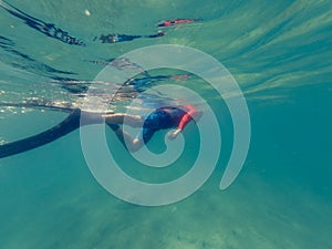 Male diver swimming in ocean enjoying summer.