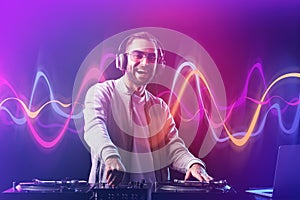 Male DJ playing music in club photo