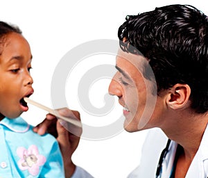 Male doctor checking little girl's throat