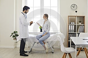 Male doctor at the clinic or hospital giving a medical consultation to a young woman