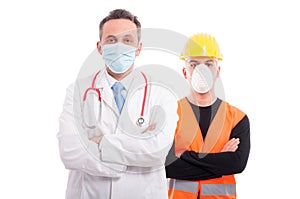 Male doctor and constructor both standing with arms crossed