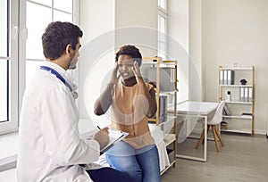 Male doctor consult black woman with headache