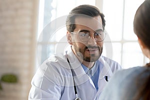 Male doctor consult patient at meeting in hospital