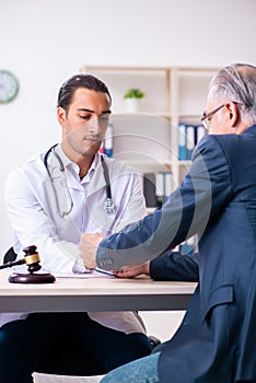 Male doctor in courthouse meeting with lawyer