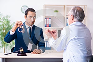 Male doctor in courthouse meeting with lawyer