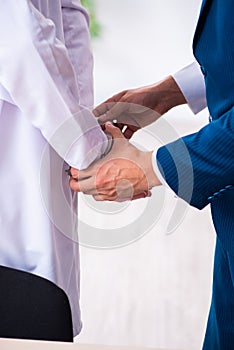 Male doctor in courthouse meeting with lawyer