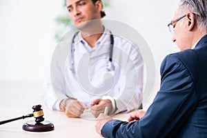 Male doctor in courthouse meeting with lawyer