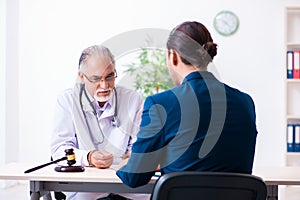 Male doctor in courthouse meeting with lawyer