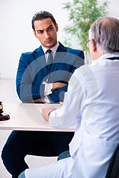 Male doctor in courthouse meeting with lawyer