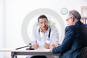 Male doctor in courthouse meeting with lawyer