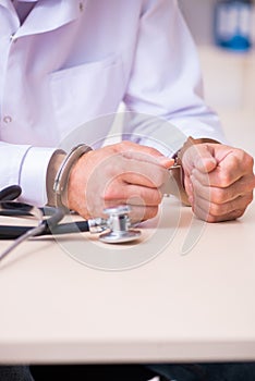 Male doctor in courthouse meeting with lawyer