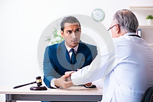 Male doctor in courthouse meeting with lawyer