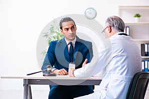 Male doctor in courthouse meeting with lawyer