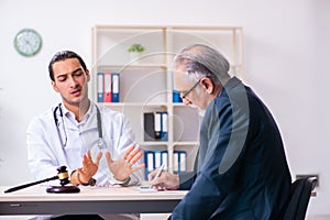 Male doctor in courthouse meeting with lawyer