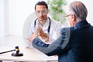 Male doctor in courthouse meeting with lawyer