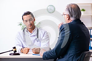 Male doctor in courthouse meeting with lawyer