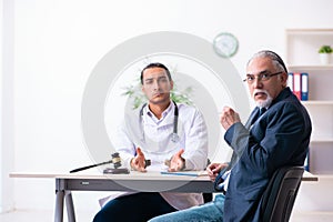 Male doctor in courthouse meeting with lawyer