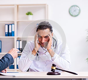 Male doctor in courthouse meeting with lawyer