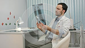 Male doctor or dentist looking at x-ray