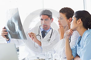 Male doctor discussing xray with colleagues