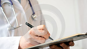 Male doctor doing paperwork in the office.