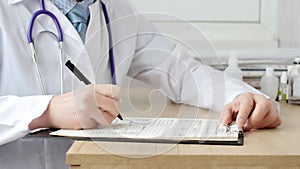 Male doctor doing paperwork in the office.