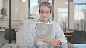 Male Doctor Doing Video Chat on Tablet