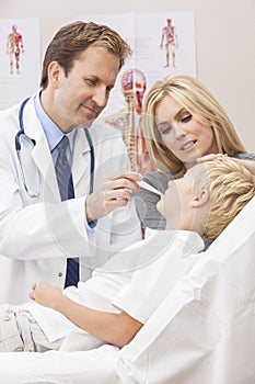 Male Doctor Examining Boy Child With Mother