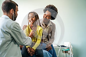 Male doctor examining a child patient in a hospital