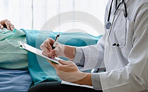 Male Doctor examining health patient in hospital room