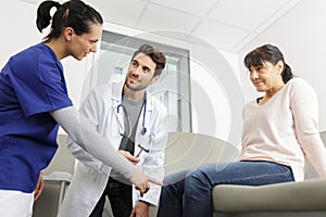 male doctor examining patient in room