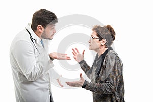 Male doctor explaining something to female senior patient