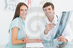 Male doctor explaining spine xray to female patient