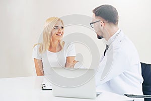 Male Doctor and Female Patient in Hospital Office