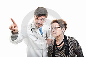 Male doctor and female senior patient using touchscreen
