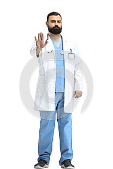 Male doctor, full-length, on a white background, shows a stop sign