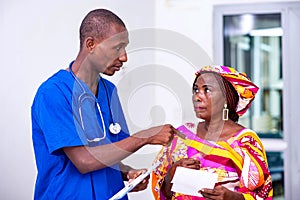 Male doctor giving advice on prescription to a patient woman