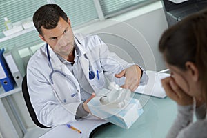 Male doctor giving handkerchiefs to female patient