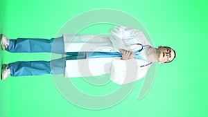 A male doctor, on a green background, in full height, pleads