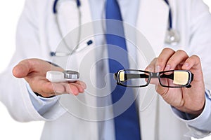 Male doctor hands giving pair of black glasses and contact lens