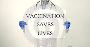 Male doctor holding banner vaccination saves lifes