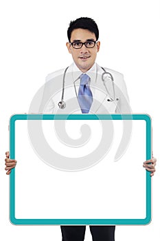 Male doctor holding empty board