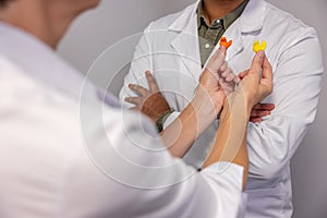 Male doctor holding hearing aid in hands