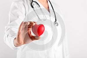 Male doctor holding heart in hands