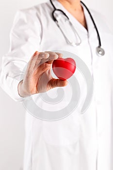 Male doctor holding heart in hands