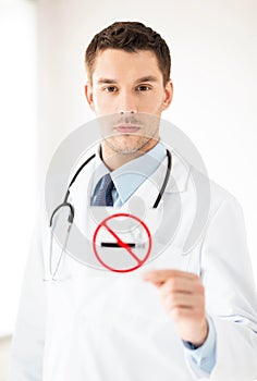 Male doctor holding no smoking sign