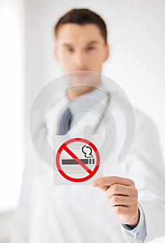 Male doctor holding no smoking sign
