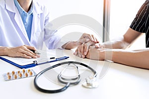 Male doctor holding patient`s hand, comforting patient who is in ambulance, helping concept